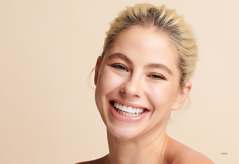 Female with happy and healthy smile after the dental treatment